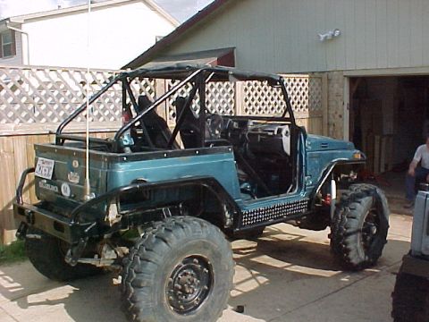 1978 Ford Bronco - This heavily modified off-road vehicle features a prominent roll cage and oversized tires, suggesting it is built for terrain.