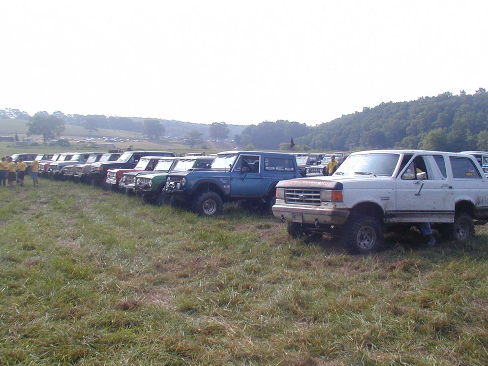 White 1987 Ford Bronco parked in a line of off-road vehicles