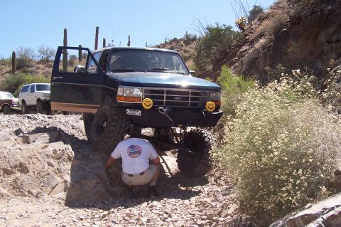 1992 Ford Bronco - This 1992 Ford Bronco is tackling a challenging off-road course in a desert landscape.