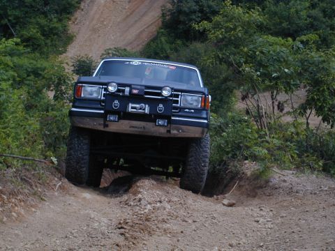 1988 Ford Bronco - This modified Ford Bronco navigates a challenging off-road trail.