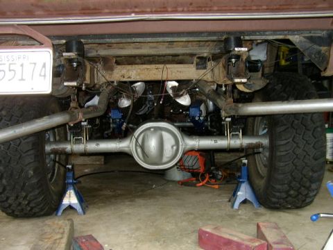 1995 Ford Bronco - Vehicle's rear axle and suspension system are visible, supported by jack stands.