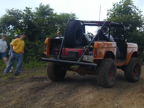 1988 Ford Bronco - This modified 1988 Ford Bronco is seen off-road with a group of people.