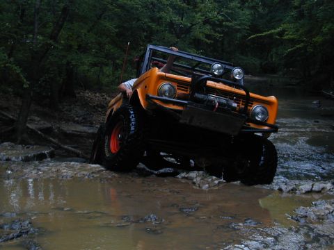 1988 Ford Bronco - This classic Bronco navigates a challenging muddy trail, its off-road capabilities.