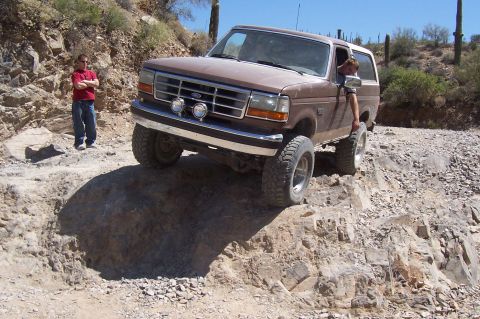 1992 Ford Bronco - This 1992 Ford Bronco tackles a challenging rocky path in a desert environment.