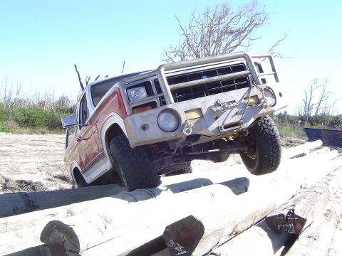 1982 Ford Bronco - This Ford F-Series truck navigates an obstacle course of logs on a sandy terrain.