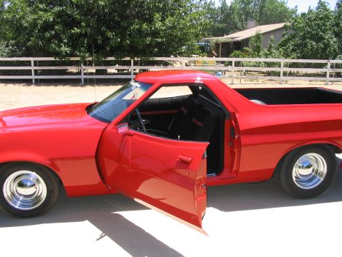 1974 Ford Ranchero - This red 1974 Ford Ranchero has its doors open, revealing the interior and a glimpse of the bed.