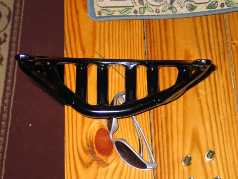 1995 Ford Bronco - Sunglasses hang from a black metal rack mounted on a wooden surface.