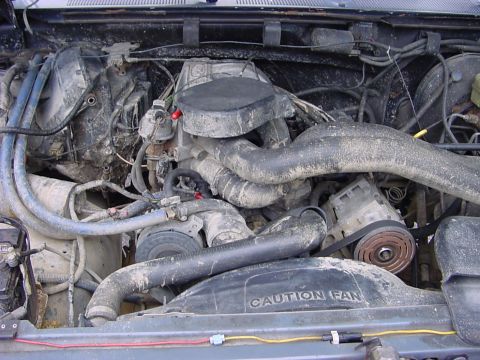 1989 Ford Bronco - The engine bay is heavily soiled, obscuring specific details about the vehicle's make and model year.