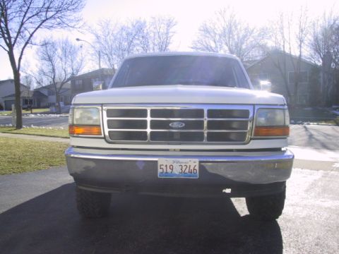 1993 Ford Bronco - Front view of a white Ford Bronco with a chrome grille and an Illinois license plate.