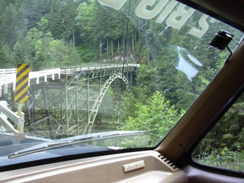 1991 Ford Bronco - Driving across a bridge in a wooded area, with trees on either side of the ravine.