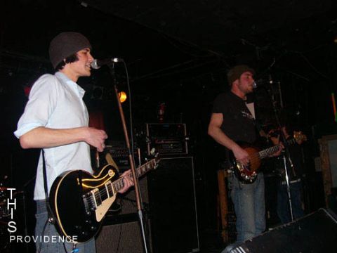 2000 Jeep Liberty - Musicians perform live on stage with guitars and microphones.