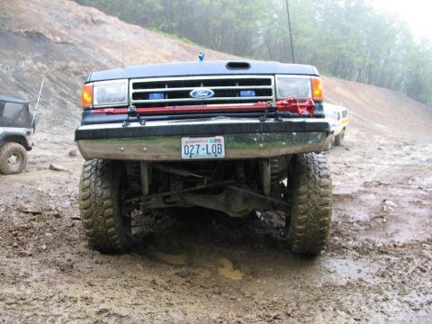 1991 Ford Bronco - This 1991 Ford Bronco is equipped with a red Hi-Lift jack mounted to its front bumper, ready for off-road adventures.