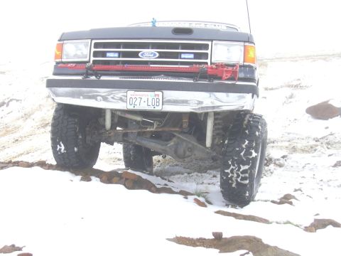 1991 Ford Bronco - This 1991 Ford Bronco is seen from the front, with large tires and a license plate reading 027-LOB.