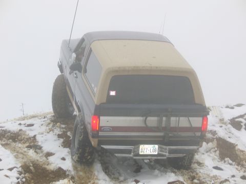 1991 Ford Bronco - This 1991 Ford Bronco is navigating a challenging snowy and muddy terrain, its off-road capabilities.