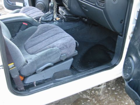 1985 Ford Bronco - Interior shot of a vehicle, focusing on the driver's seat and floor area.