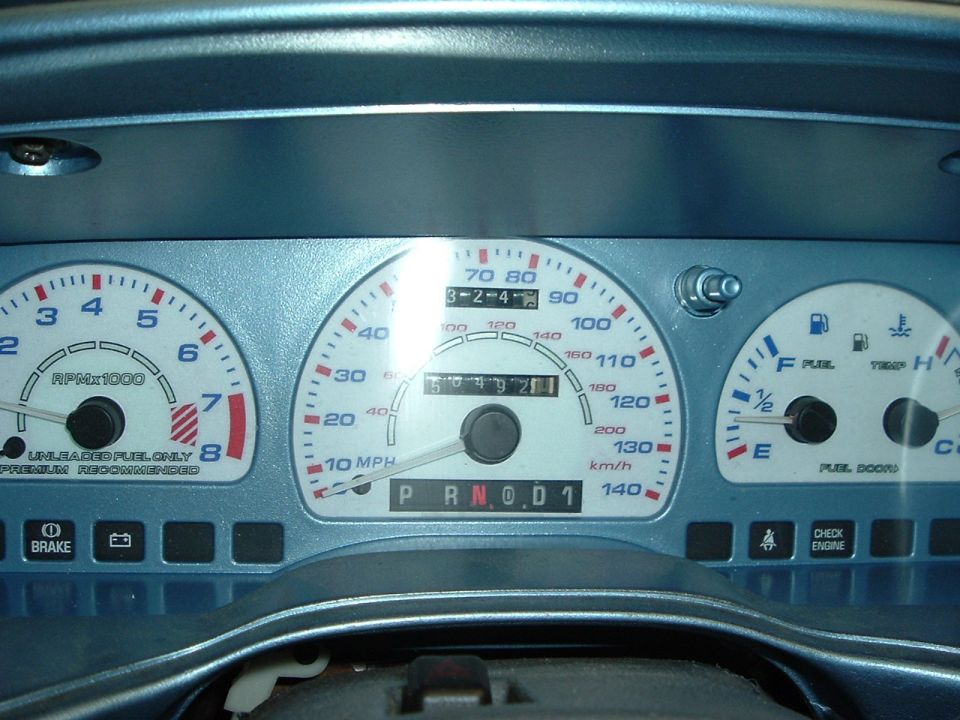 Dashboard gauges with tachometer, speedometer, fuel, and temperature gauges. Odometer reads 504921