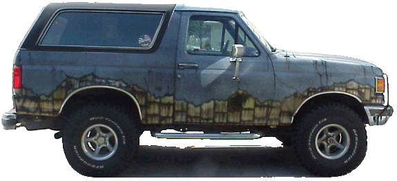 Side view of dark Ford Bronco SUV with airbrushed stone graphics and chrome wheels