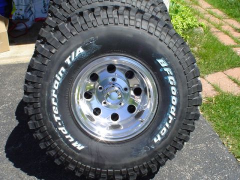 1993 Ford Bronco - BFGoodrich Mud-Terrain T/A tires with chrome wheels are stacked.