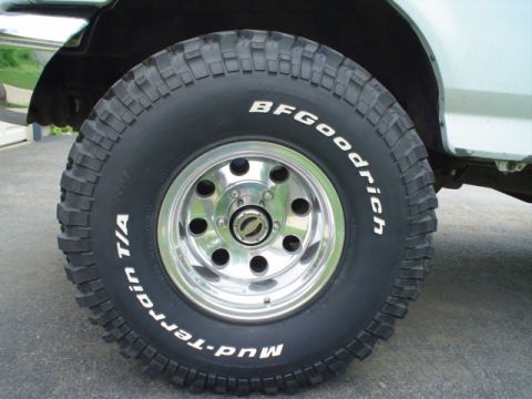 1993 Ford Bronco - Close-up of a BFGoodrich Mud-Terrain T/A tire mounted on a chrome wheel.