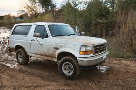 1993 Ford Bronco - This 1993 Ford Bronco is navigating a wet, muddy off-road path.