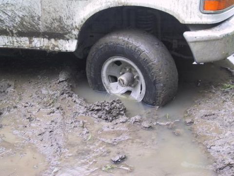 1993 Ford Bronco - This 1993 Ford Bronco is deeply stuck in the mud, with its front wheel submerged.