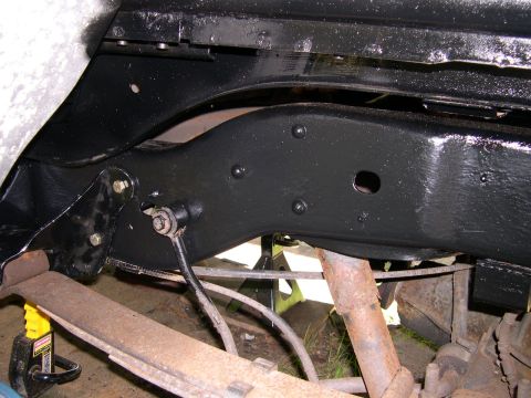 1994 Ford Bronco - Close-up view of the undercarriage of a vehicle, showing the frame and suspension parts.