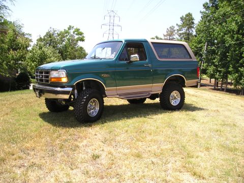 1996 Ford Bronco - This lifted 1996 Ford Bronco features a two-tone green and tan paint scheme and aggressive off-road tires.