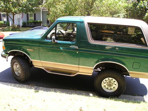 1996 Ford Bronco - This lifted 1996 Ford Bronco has a two-tone green and tan paint scheme with a white roof.