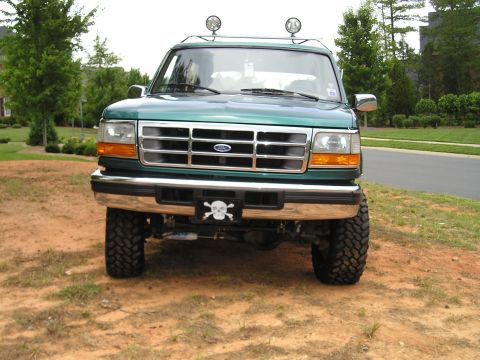 1996 Ford Bronco - This lifted 1996 Ford Bronco features a prominent grille and a decorative skull license plate frame.