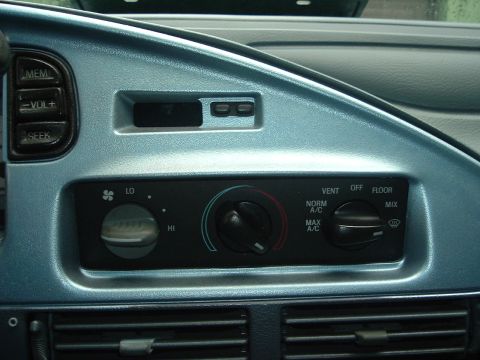 1993 Ford Taurus - Close-up of the car's dashboard showing the climate control panel and radio buttons.