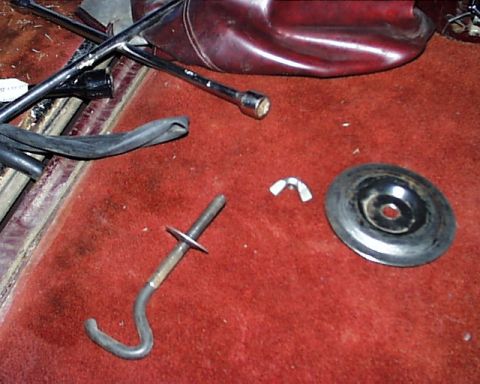 1988 Ford C-350 (Centurion Conversions) - Interior view of a vehicle's cargo area showing tools and spare tire hardware.