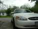2003 Ford Taurus - Front view of a white 2003 Ford Taurus parked on a cloudy day.
