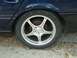 1993 Ford Taurus - Close-up of a blue car's alloy wheel and tire, showing the five-spoke design.
