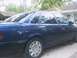 1993 Ford Taurus - A dark blue sedan is parked outdoors, showing its side profile. The vehicle appears to be from the 1990s.