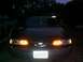 1993 Ford Taurus - A car is seen from the rear at night, with its taillights illuminated.