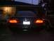 1993 Ford Taurus - Rear view of a 1993 Ford Taurus at dusk, showing its distinctive taillights.