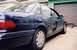 1993 Ford Taurus - Rear view of a dark blue 1993 Ford Taurus sedan, showing the taillight and quarter panel.