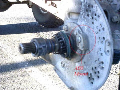 1995 Ford Bronco - A detailed view of a vehicle's wheel hub assembly, highlighting the ABS mount.