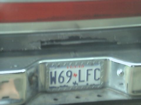 1989 Ford Bronco - A license plate with the characters W69-LFC is visible on the rear of a vehicle.