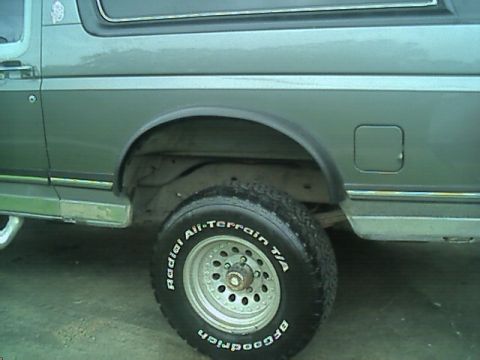 1989 Ford Bronco - Side view of a 1989 Ford Bronco, showing the rear wheel and fender area with BFGoodrich tires.
