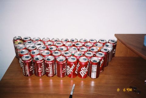 1988 Ford Bronco - A collection of Dr. Pepper cans, some opened, are displayed on a table.