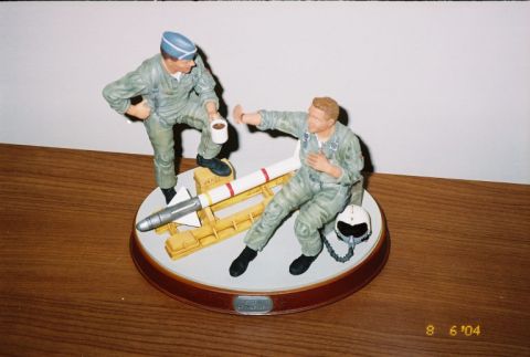 1988 Ford Bronco - A display piece depicts two pilots interacting near a missile on a wooden surface.