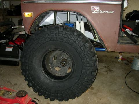 1995 Ford Bronco - This Ford Bronco is undergoing modifications, a large tire and exposed suspension.
