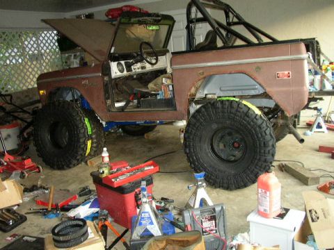 1995 Ford Bronco - This 1974 Ford Bronco is undergoing modifications in a garage, oversized tires and a roll cage.