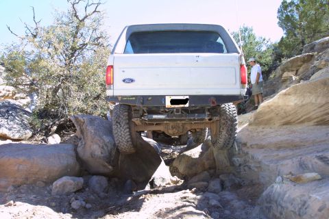 1987 Ford Bronco - This 1987 Ford Bronco is tackling a challenging rocky trail, demonstrating its off-road capability.