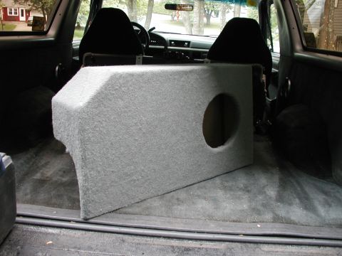 1994 Ford Bronco - A custom-built subwoofer box is installed in the cargo area of an SUV, obscuring the rear seating.