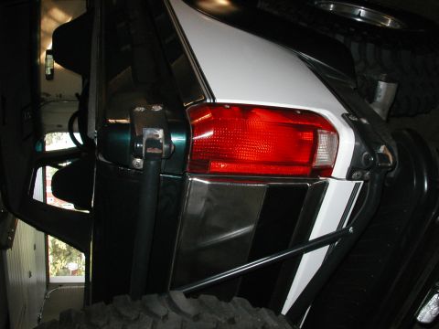 1994 Ford Bronco - Rear view of a modified Ford Bronco, showing custom paint and off-road accessories.