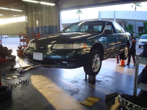 1993 Ford Taurus - SHO up in the air.. for the tires to be taken off.