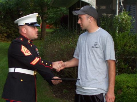 1994 Ford Bronco - A Marine in dress blues shakes hands with a civilian outside a home.