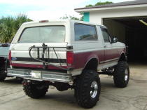 1993 Ford Bronco - This lifted 1993 Ford Bronco is shown from the rear, a spare tire carrier mounted on the tailgate.